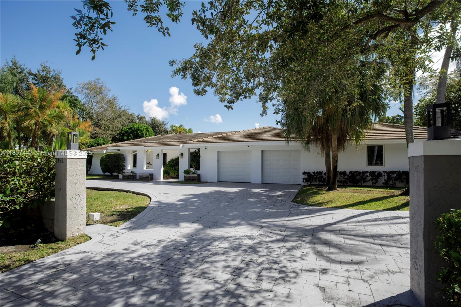 13551 Southwest 62nd Avenue Pinecrest, FL 33156 - Photo 1 of 70 a front view of a house with swimming pool and trees