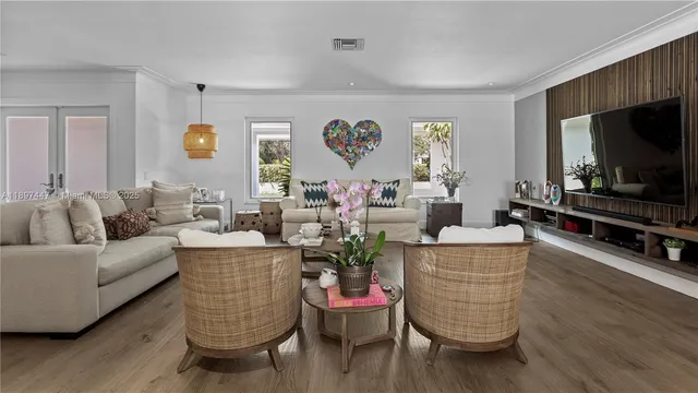 a living room with furniture and wooden floor