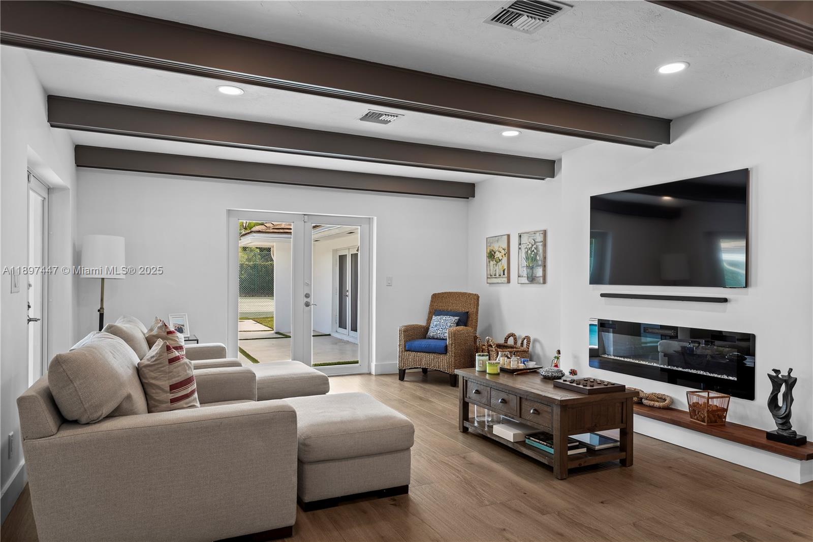 13551 Southwest 62nd Avenue Pinecrest, FL 33156 - Photo 14 of 70 a living room with furniture and a flat screen tv