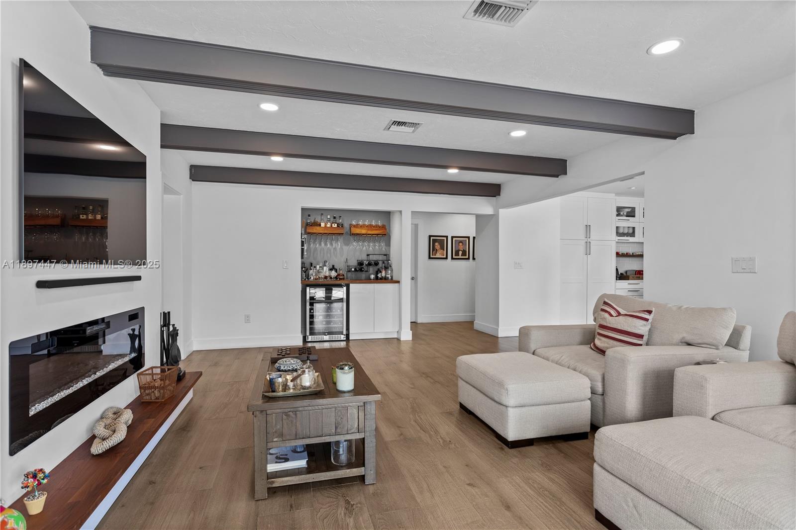 13551 Southwest 62nd Avenue Pinecrest, FL 33156 - Photo 16 of 70 a living room with furniture and a flat screen tv