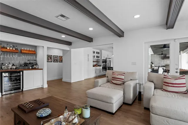 a kitchen with stainless steel appliances a table and chairs in it