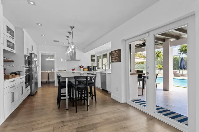 a view of a dining room with furniture and chandelier