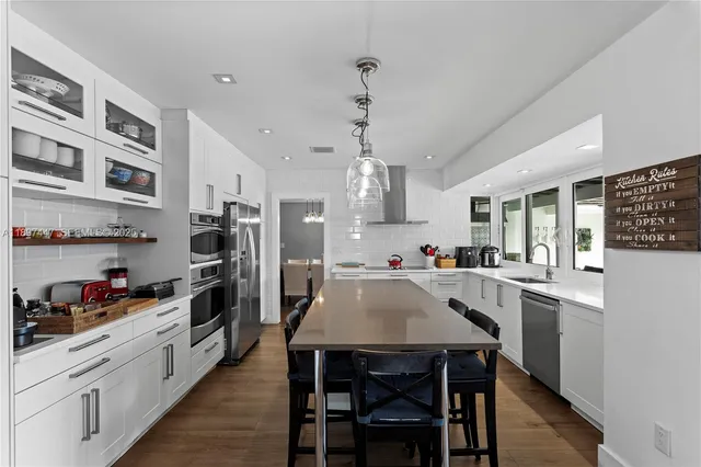a view of a dining room with furniture wooden floor and chandelier