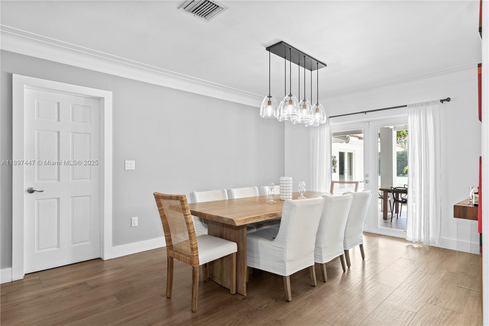 13551 Southwest 62nd Avenue Pinecrest, FL 33156 - Photo 27 of 70 a view of a dining room with furniture wooden floor and chandelier