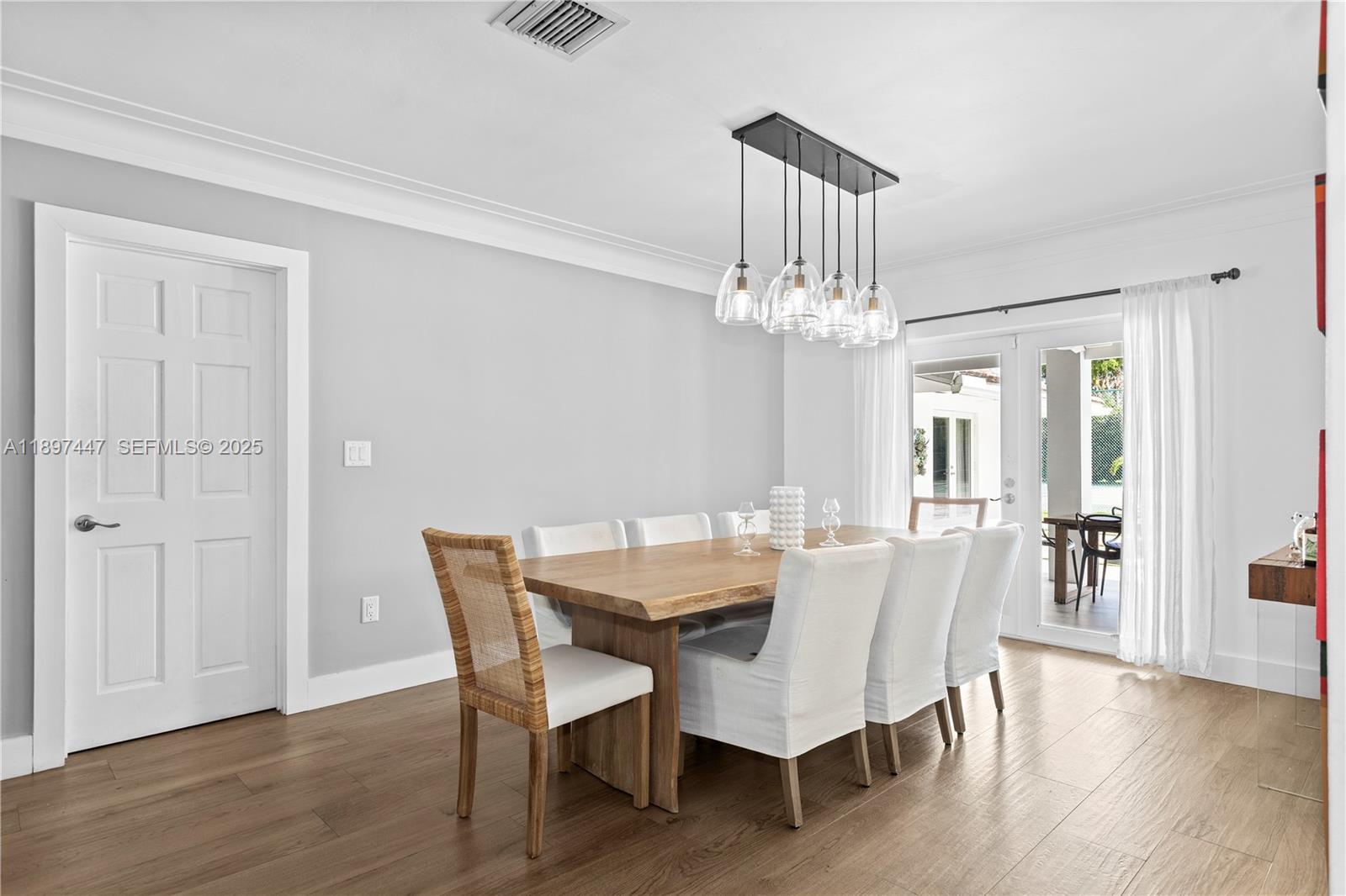 13551 Southwest 62nd Avenue Pinecrest, FL 33156 - Photo 27 of 70 a view of a dining room with furniture wooden floor and chandelier