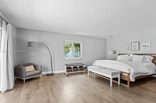 a bedroom with a large bed and a window