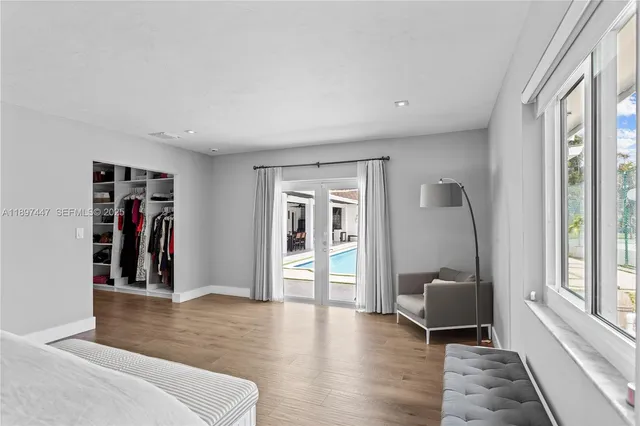 a bedroom with a bed couch and a window