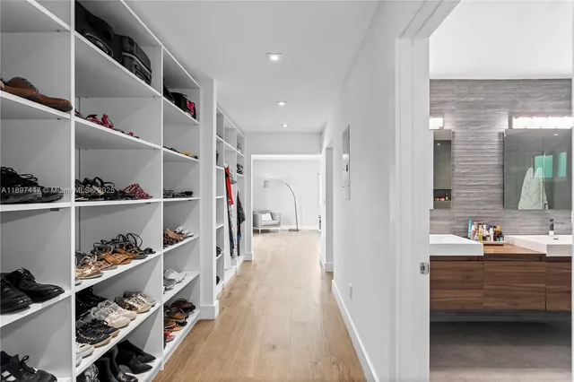 a bathroom with a granite countertop sink a mirror and shower