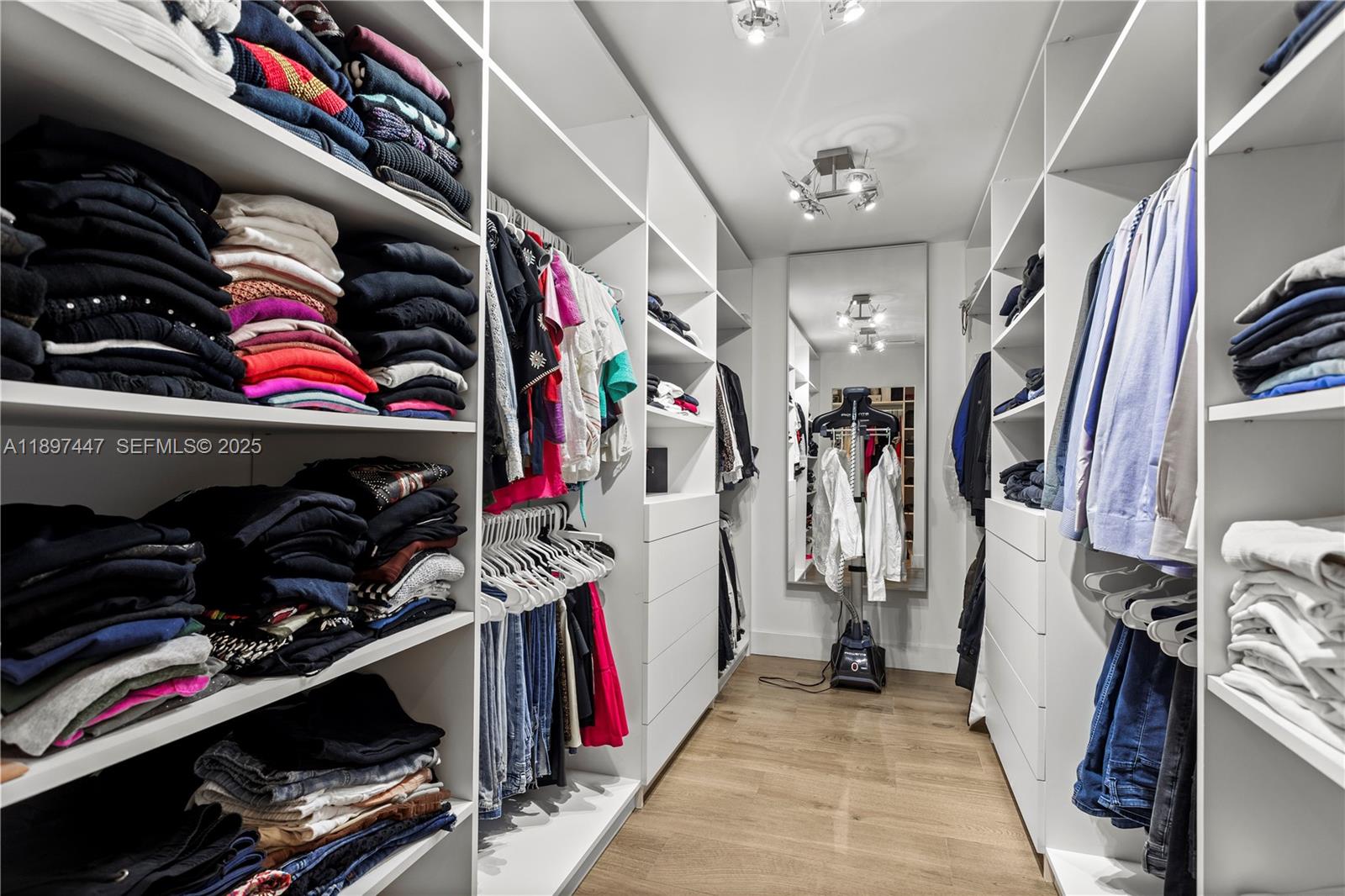 13551 Southwest 62nd Avenue Pinecrest, FL 33156 - Photo 32 of 70 a view of walk in closet with clothes and shoes