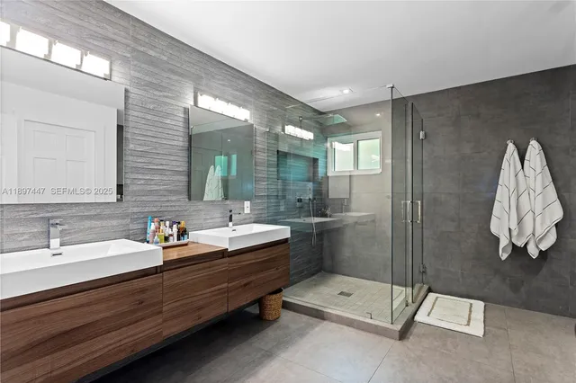 a bathroom with a toilet sink shower and mirror