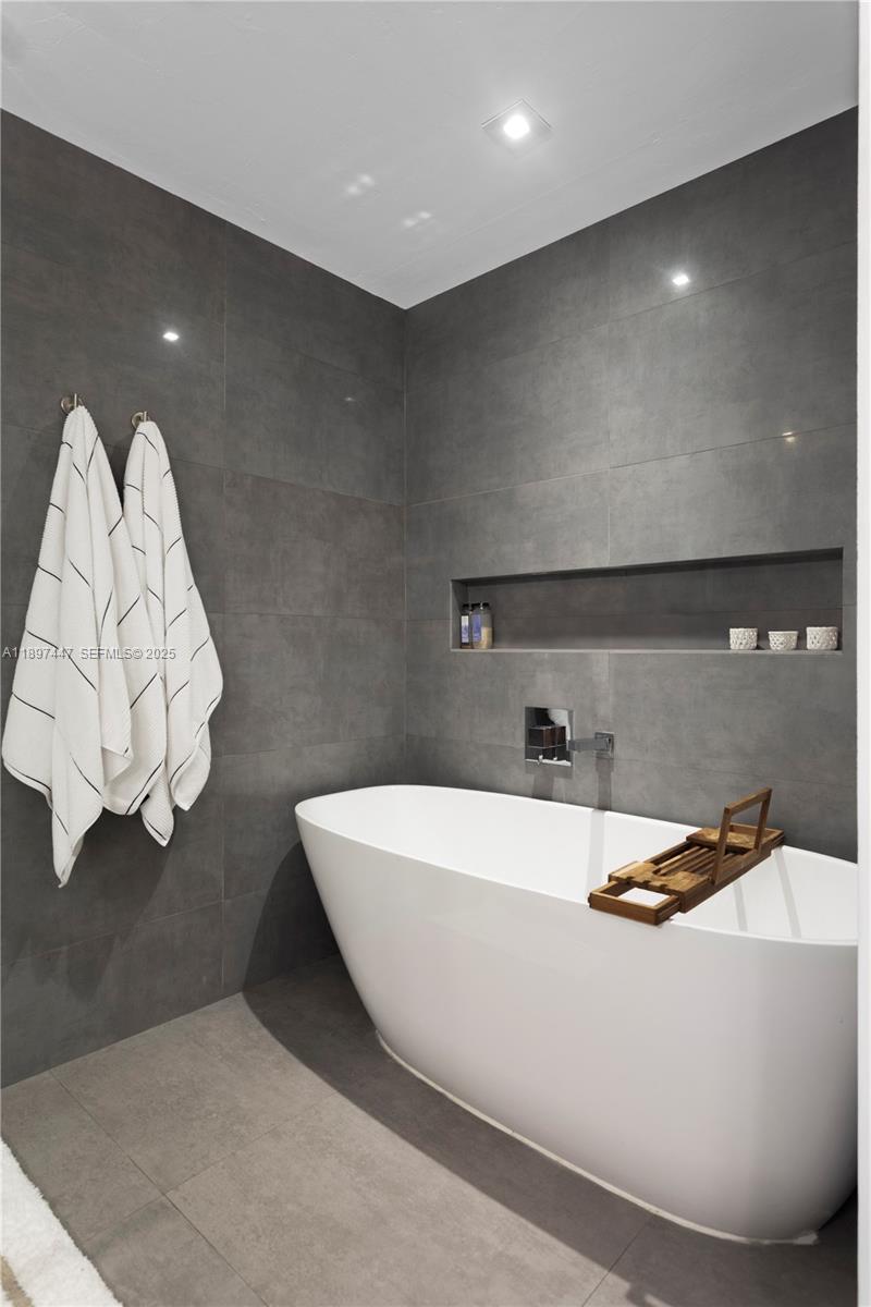 13551 Southwest 62nd Avenue Pinecrest, FL 33156 - Photo 35 of 70 a white bath tub sitting in a bathroom