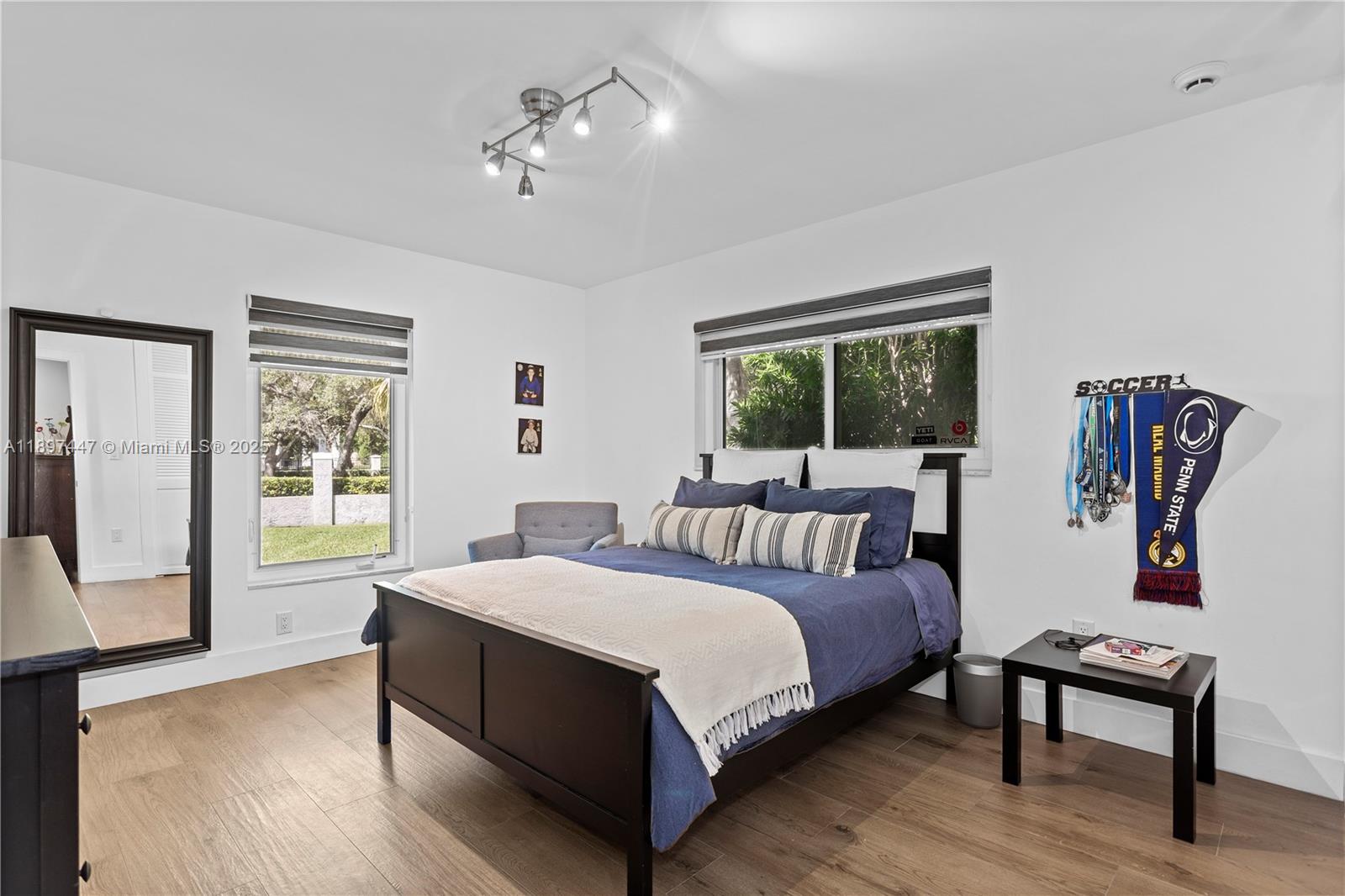 13551 Southwest 62nd Avenue Pinecrest, FL 33156 - Photo 37 of 70 a bedroom with a large bed and a window