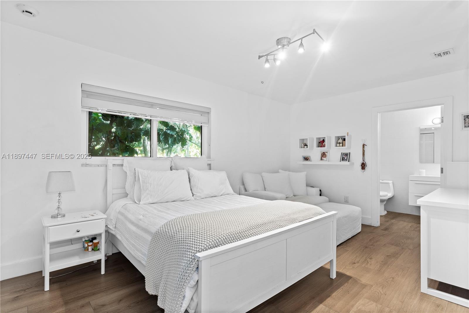 13551 Southwest 62nd Avenue Pinecrest, FL 33156 - Photo 40 of 70 a room with a bed and a large window