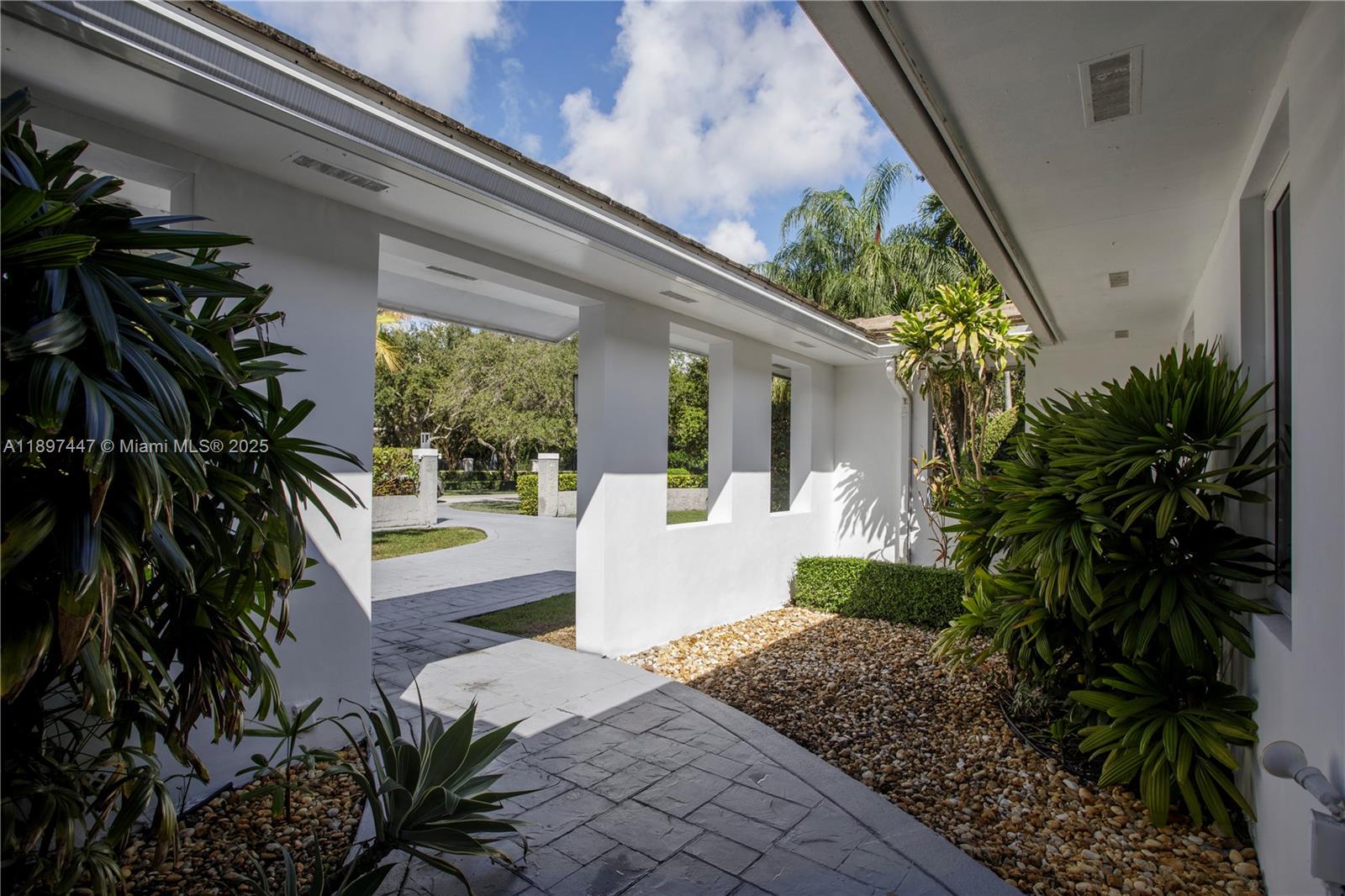 13551 Southwest 62nd Avenue Pinecrest, FL 33156 - Photo 4 of 70 a front view of a house with a porch