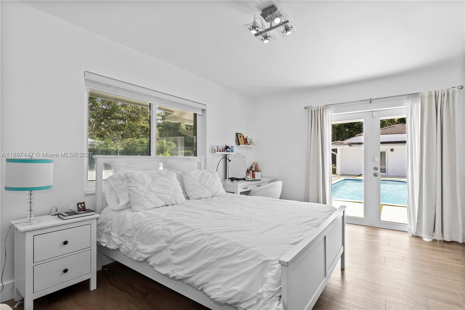 13551 Southwest 62nd Avenue Pinecrest, FL 33156 - Photo 43 of 70 a bedroom with a large bed and a window