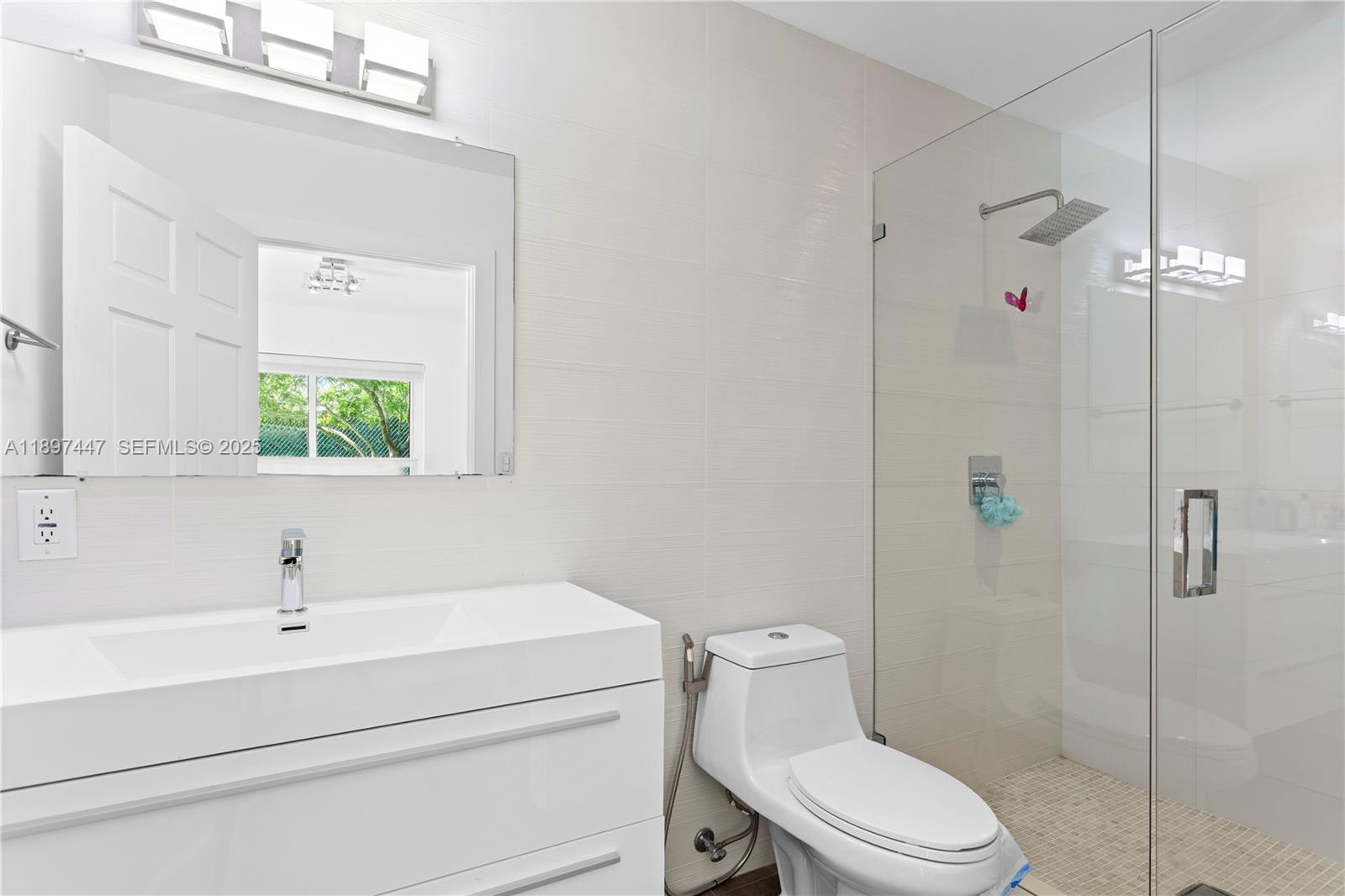 13551 Southwest 62nd Avenue Pinecrest, FL 33156 - Photo 44 of 70 a bathroom with a sink a toilet and shower