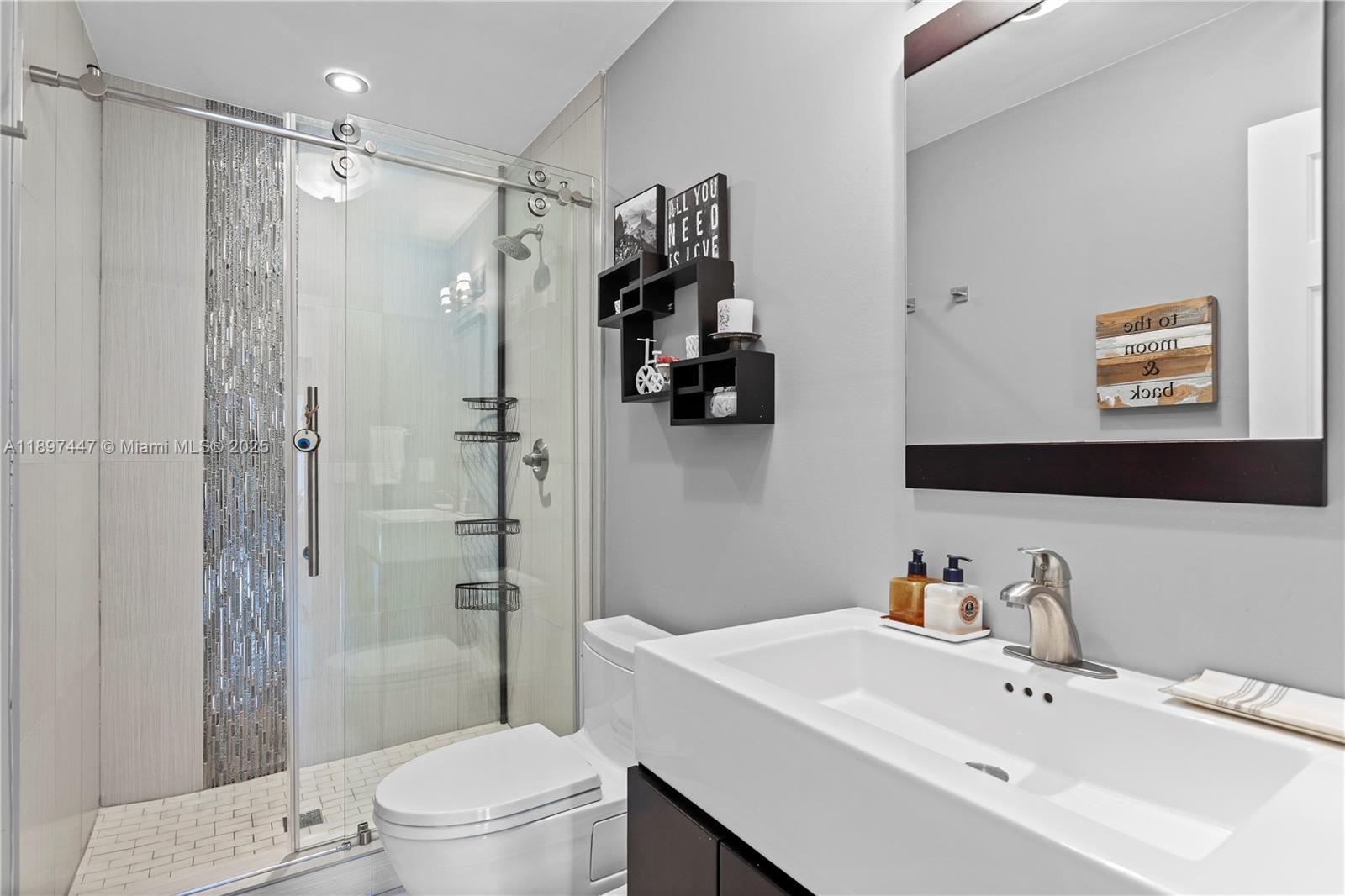 13551 Southwest 62nd Avenue Pinecrest, FL 33156 - Photo 45 of 70 a bathroom with a sink toilet and shower