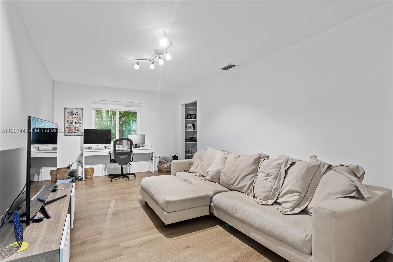 13551 Southwest 62nd Avenue Pinecrest, FL 33156 - Photo 47 of 70 a living room with furniture and a flat screen tv