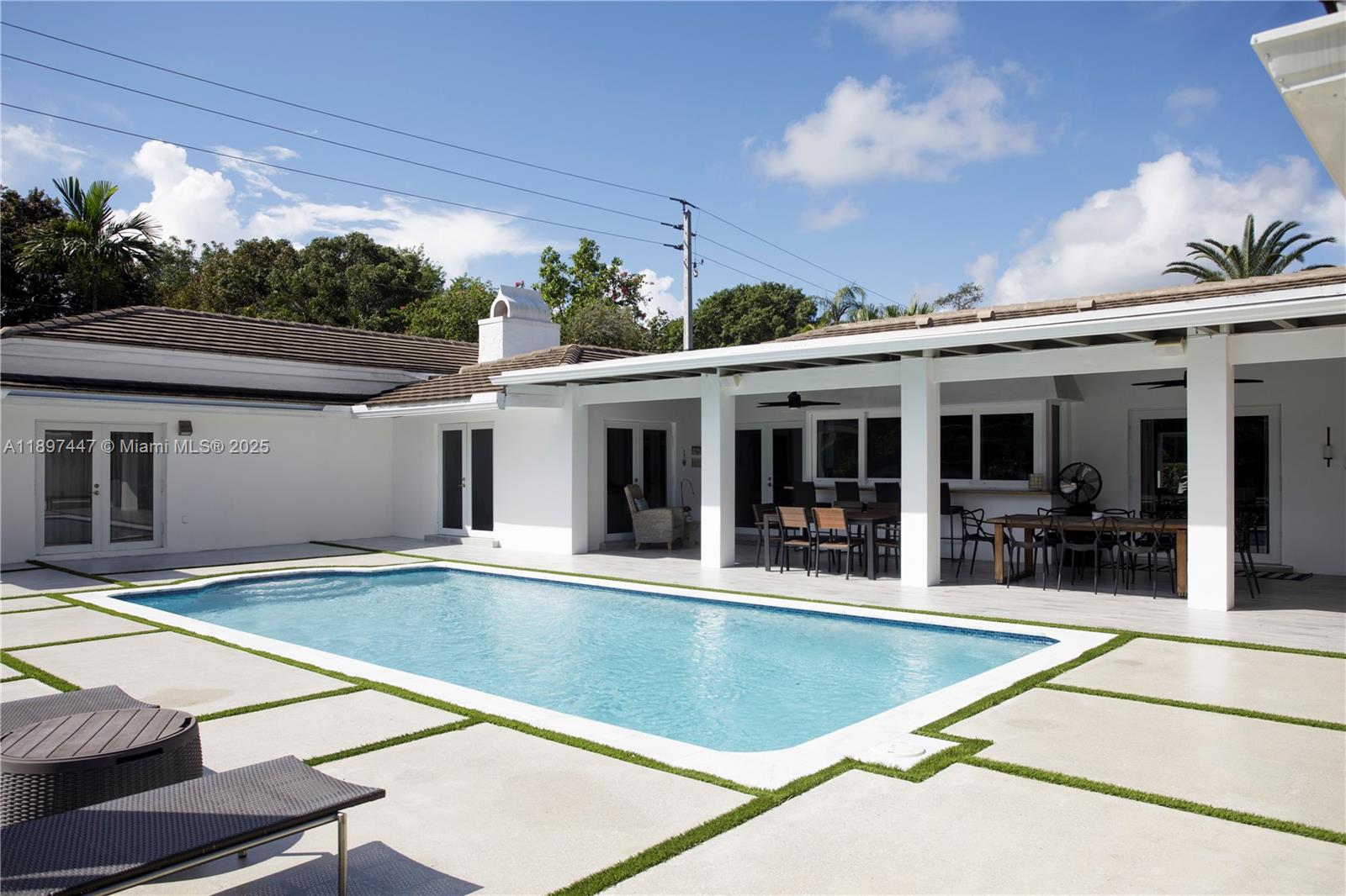13551 Southwest 62nd Avenue Pinecrest, FL 33156 - Photo 50 of 70 a view of a house with swimming pool and sitting area