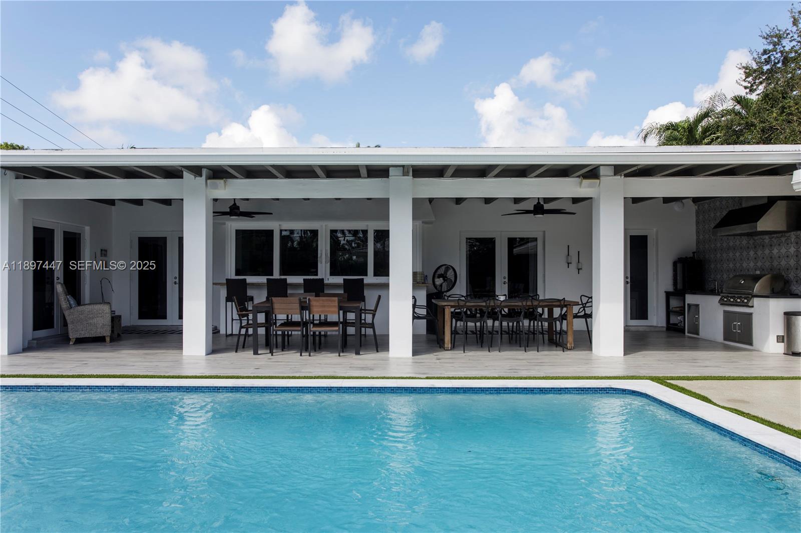 13551 Southwest 62nd Avenue Pinecrest, FL 33156 - Photo 51 of 70 an outdoor space with swimming pool and furniture