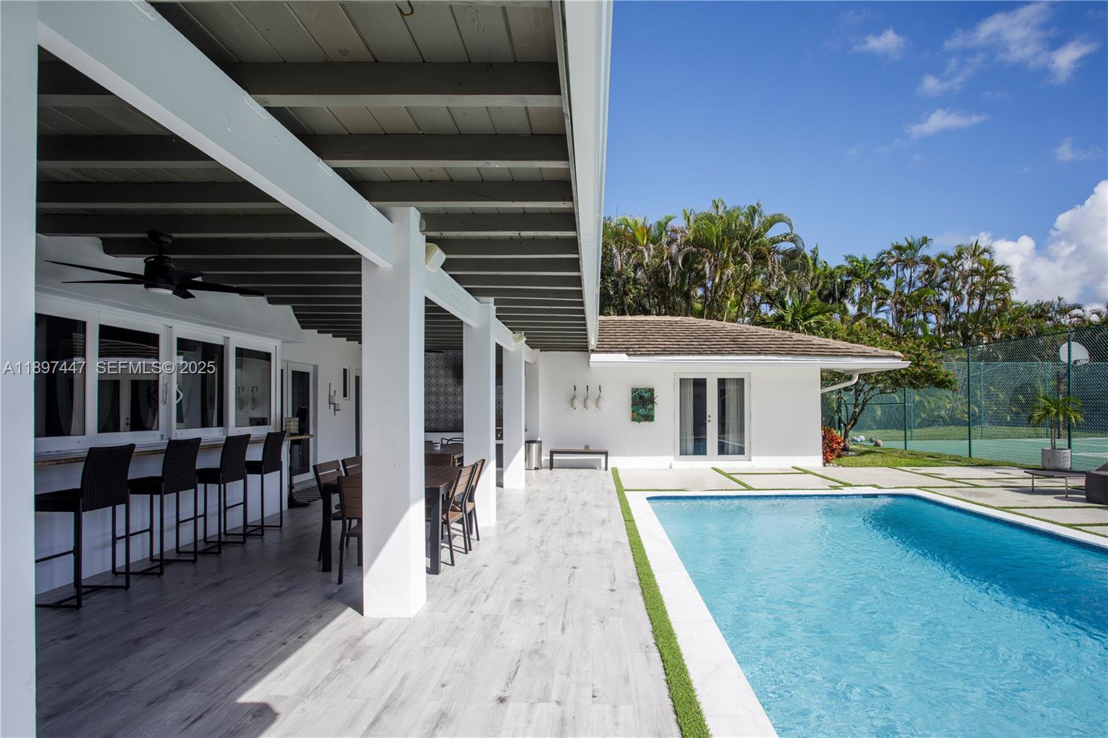 13551 Southwest 62nd Avenue Pinecrest, FL 33156 - Photo 55 of 70 a view of a house with pool and sitting area