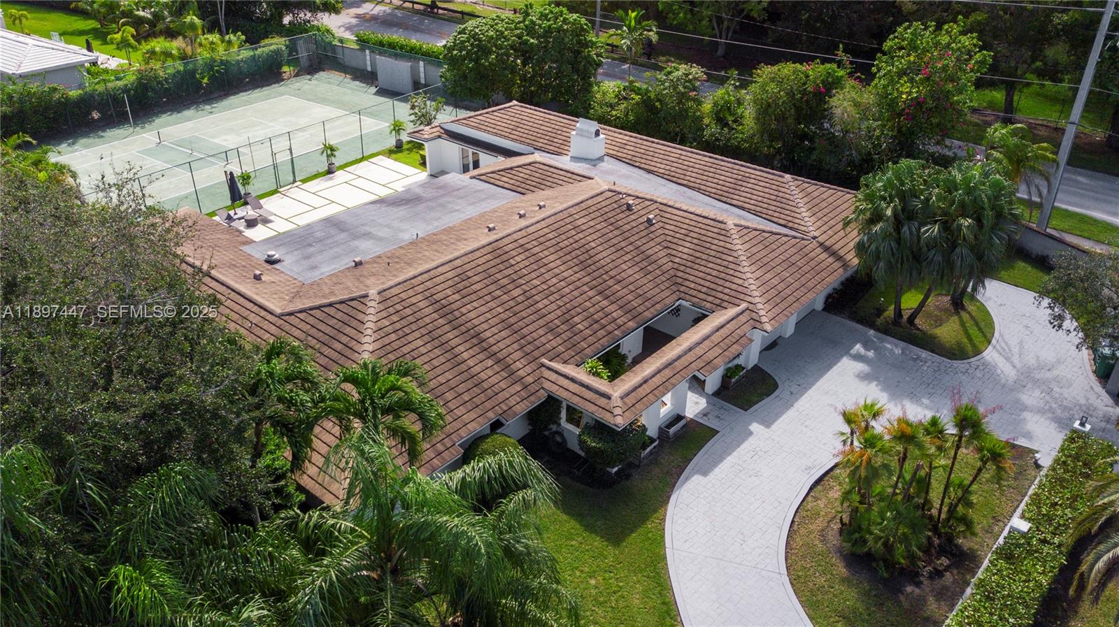 13551 Southwest 62nd Avenue Pinecrest, FL 33156 - Photo 69 of 70 an aerial view of a house with a yard and lake view