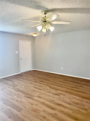a view of a room with wooden floor