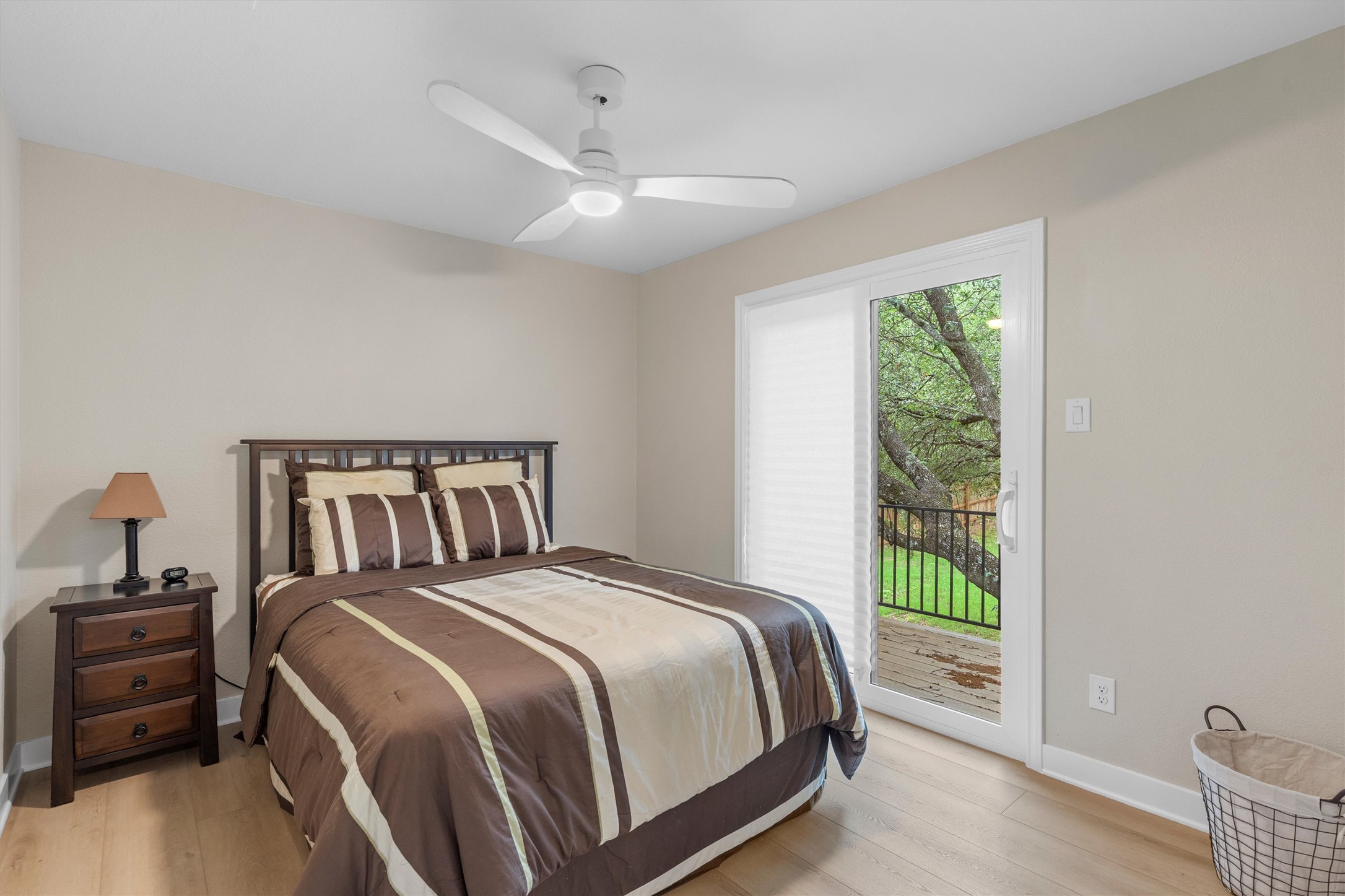 307 Hurst Creek Road Austin, TX 78734 - Photo 25 of 40 Room featuring wood-finish flooring, a ceiling fan with integrated lighting, and a sliding glass door