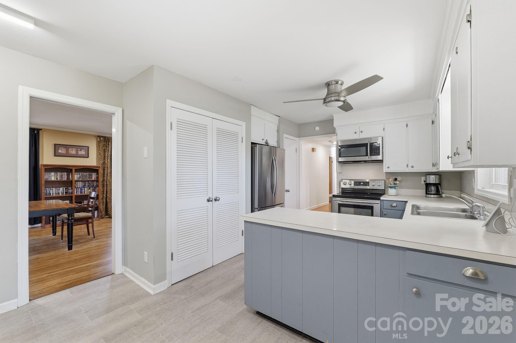 11715 Timber Ridge Road Charlotte, NC 28213 - Photo 11 of 38 a kitchen with stainless steel appliances a sink a stove a refrigerator cabinets and a window