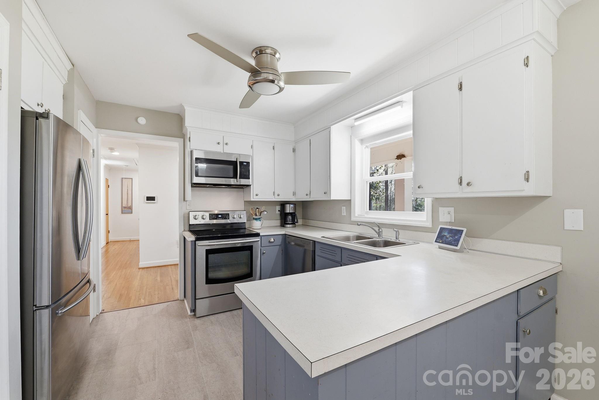 11715 Timber Ridge Road Charlotte, NC 28213 - Photo 12 of 38 a kitchen with a sink a stove and refrigerator