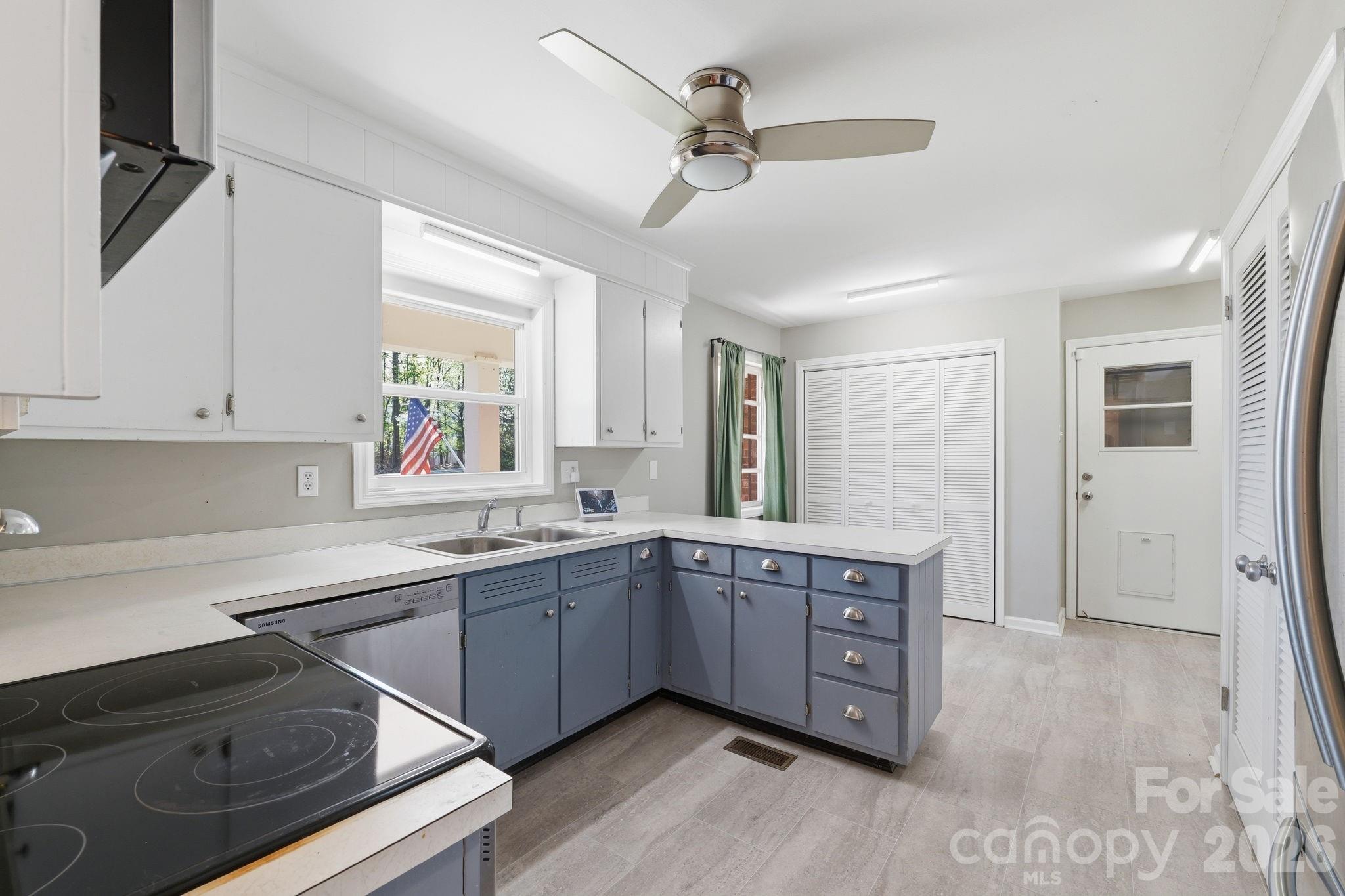 11715 Timber Ridge Road Charlotte, NC 28213 - Photo 14 of 38 a kitchen with sink cabinets and wooden floor