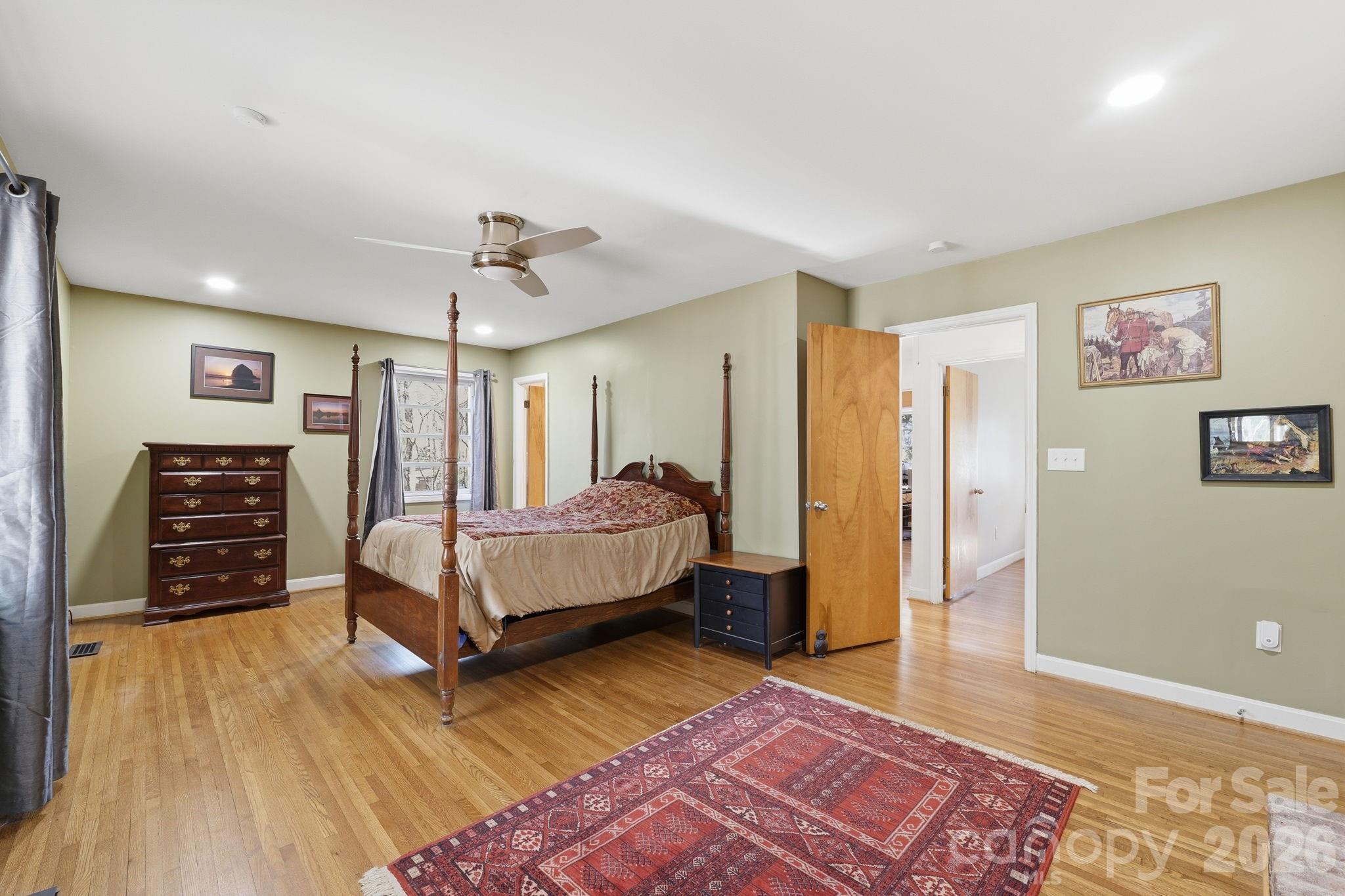 11715 Timber Ridge Road Charlotte, NC 28213 - Photo 22 of 38 a spacious bedroom with a bed and a chandelier