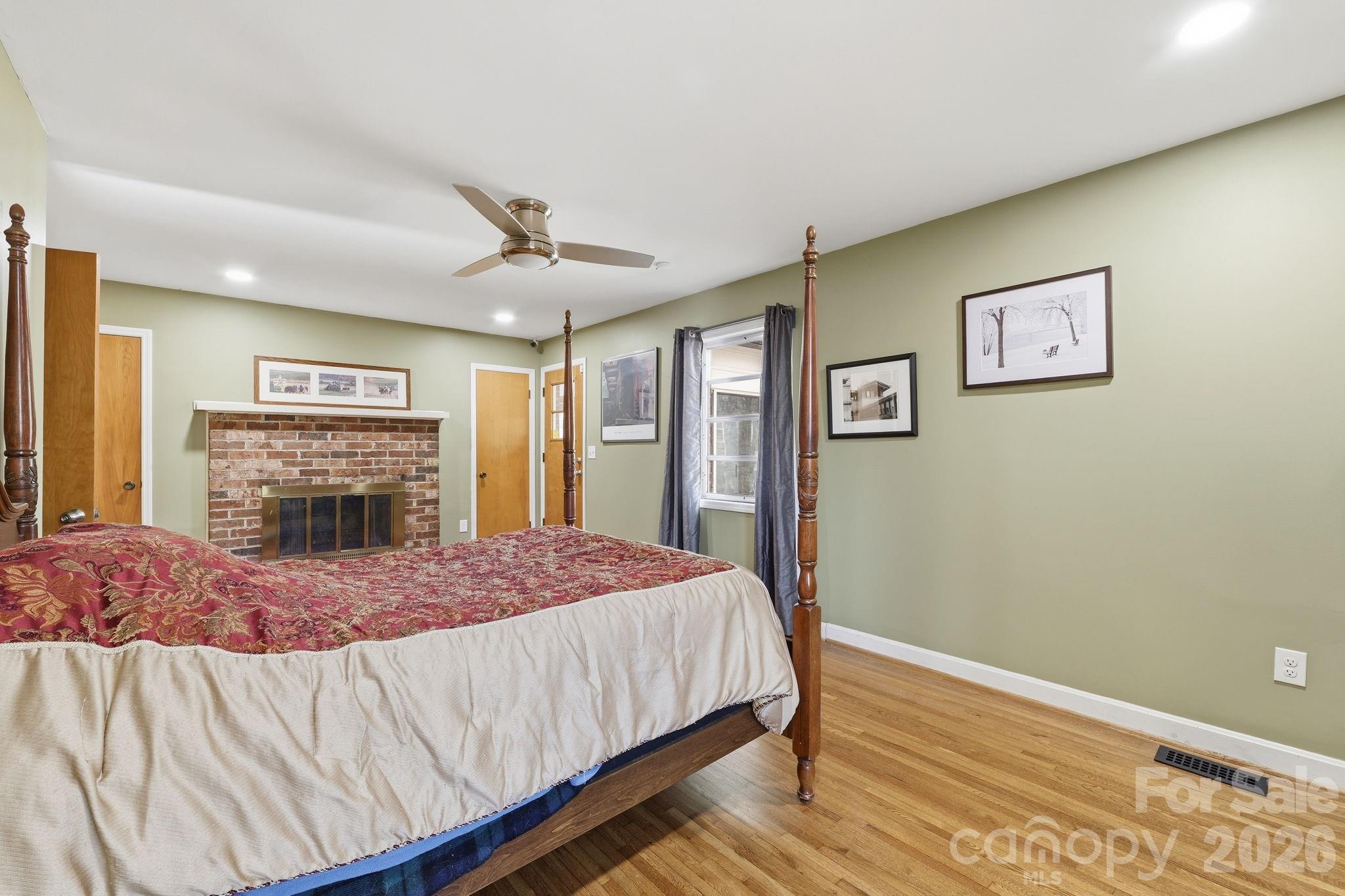 11715 Timber Ridge Road Charlotte, NC 28213 - Photo 24 of 38 a bedroom with a bed and a flat screen tv