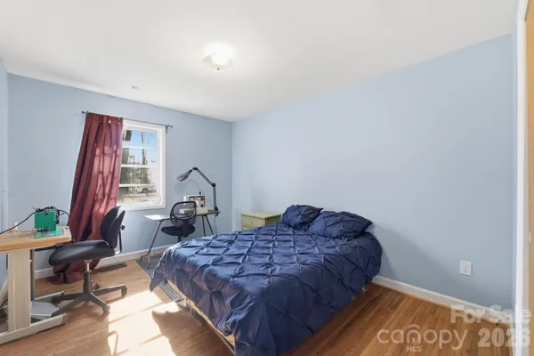 a bed sitting in a bedroom next to a window