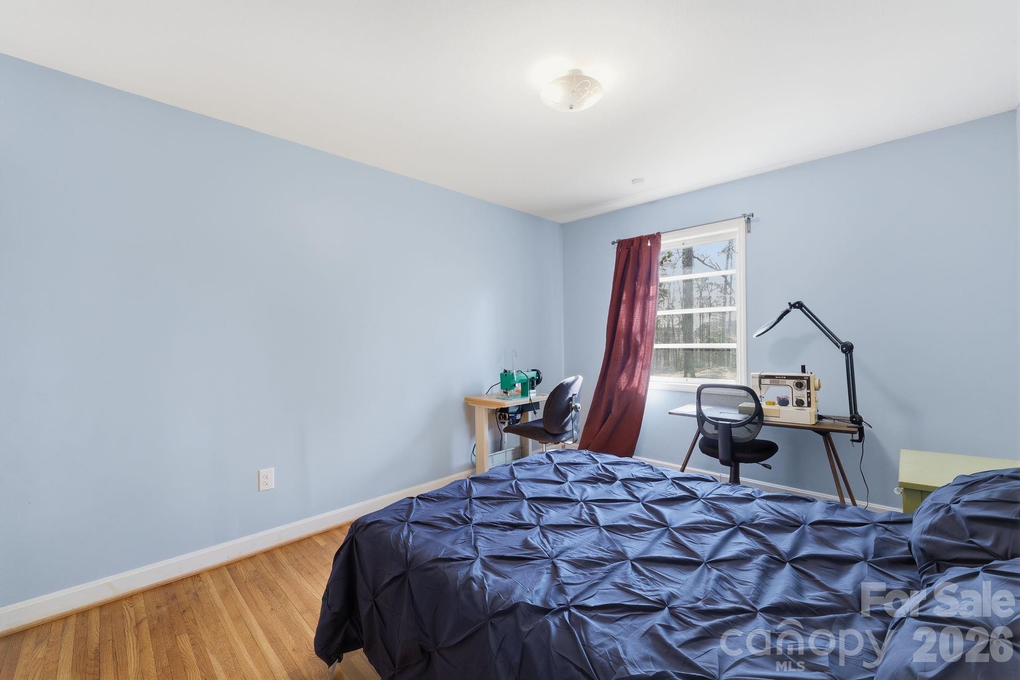 11715 Timber Ridge Road Charlotte, NC 28213 - Photo 31 of 38 a bedroom with a bed and wooden floor
