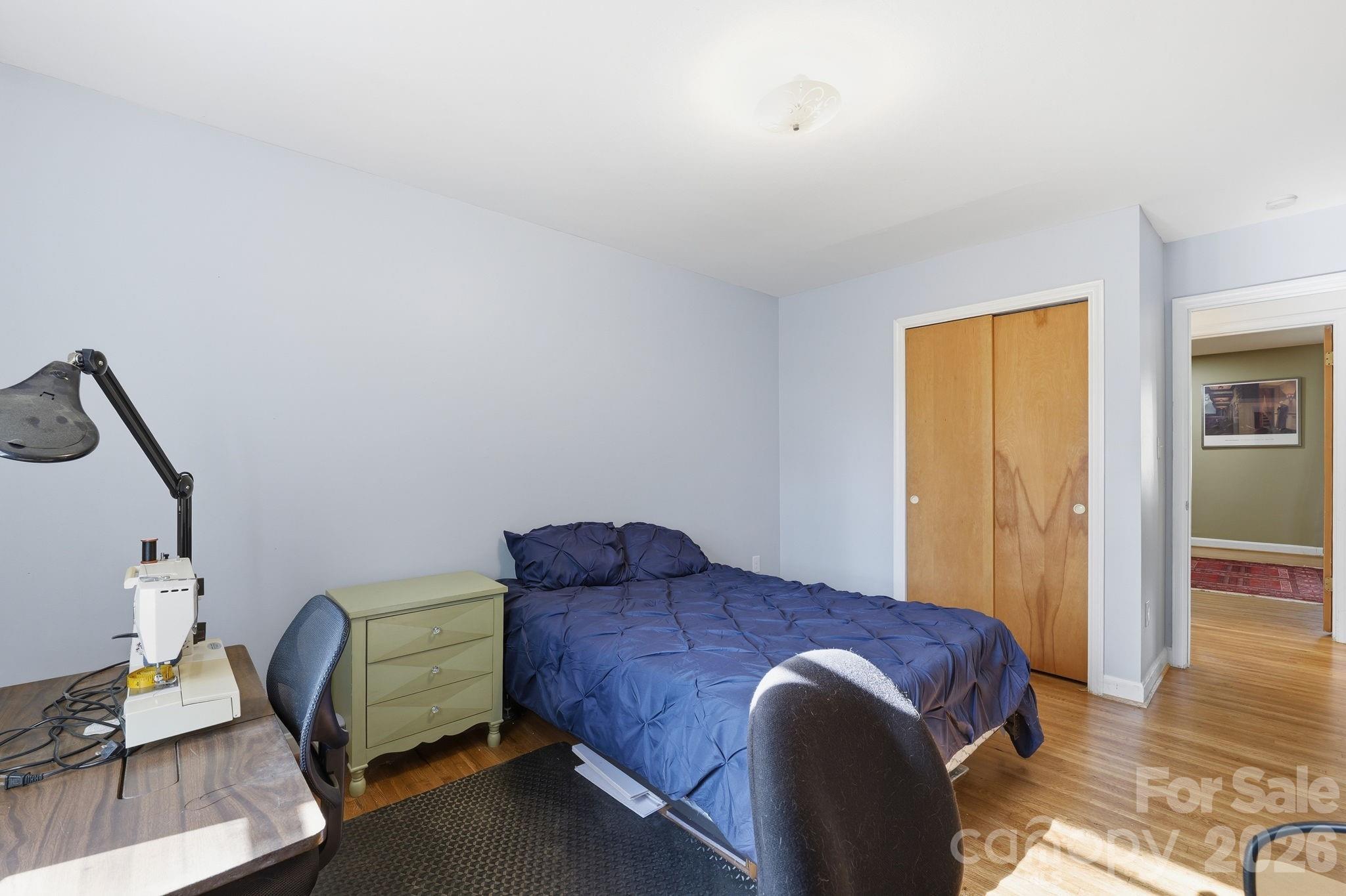 11715 Timber Ridge Road Charlotte, NC 28213 - Photo 32 of 38 a bedroom with a bed chair and wooden floor