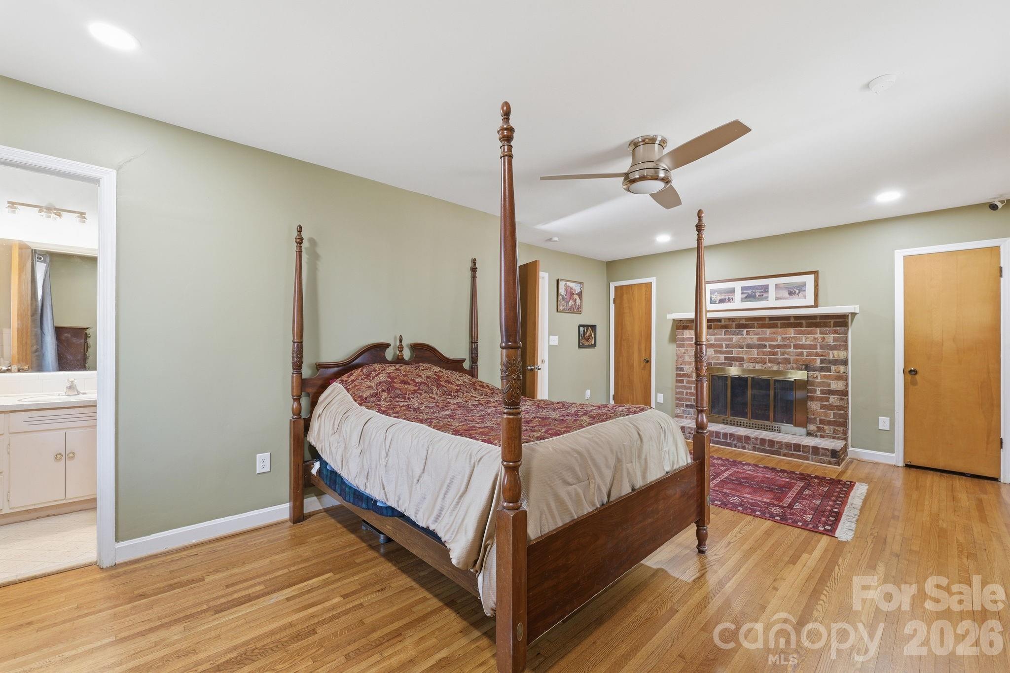 11715 Timber Ridge Road Charlotte, NC 28213 - Photo 4 of 38 a bedroom with a bed and wooden floor