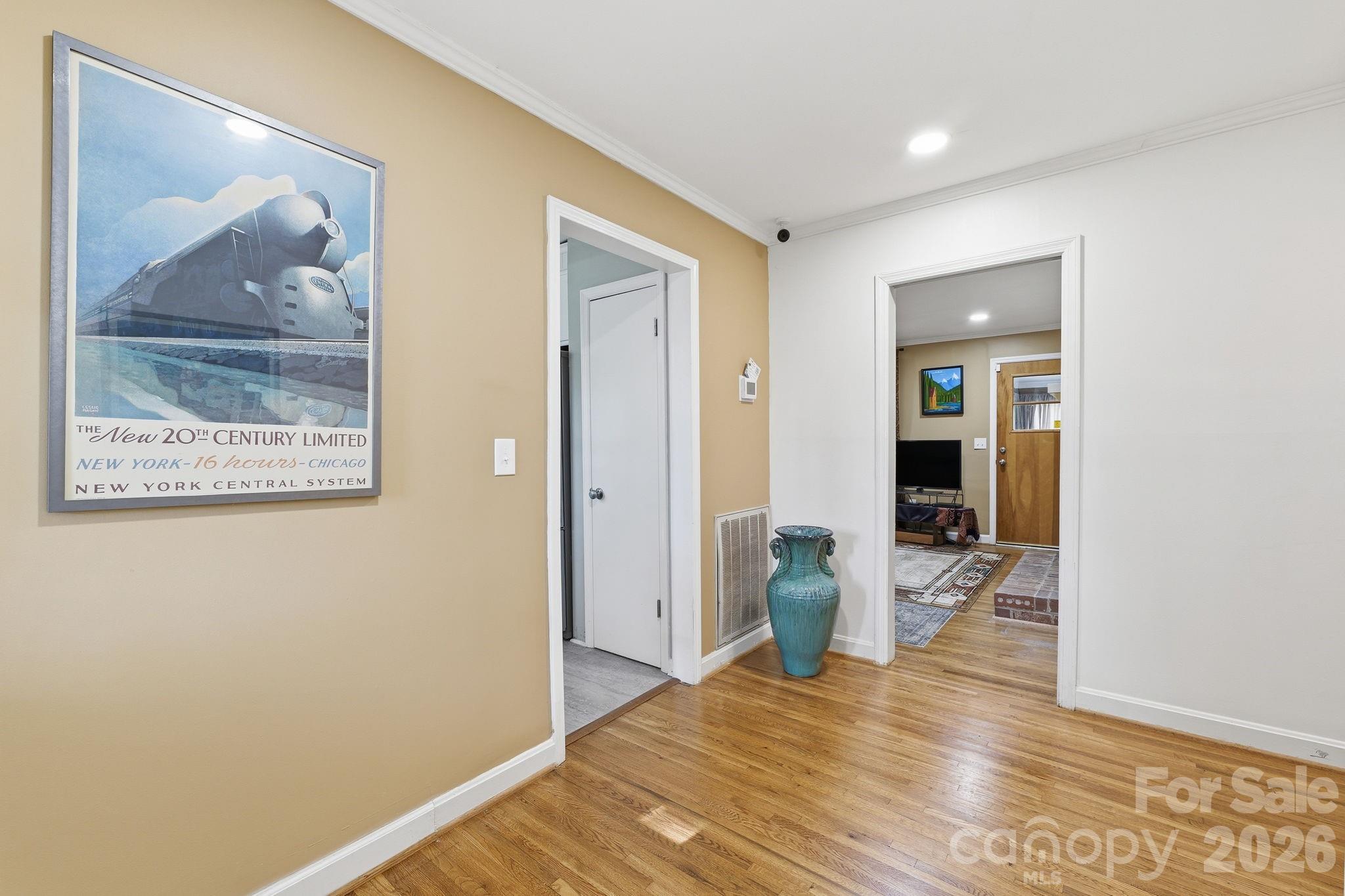 11715 Timber Ridge Road Charlotte, NC 28213 - Photo 7 of 38 a view of a hallway with wooden floor and a living room