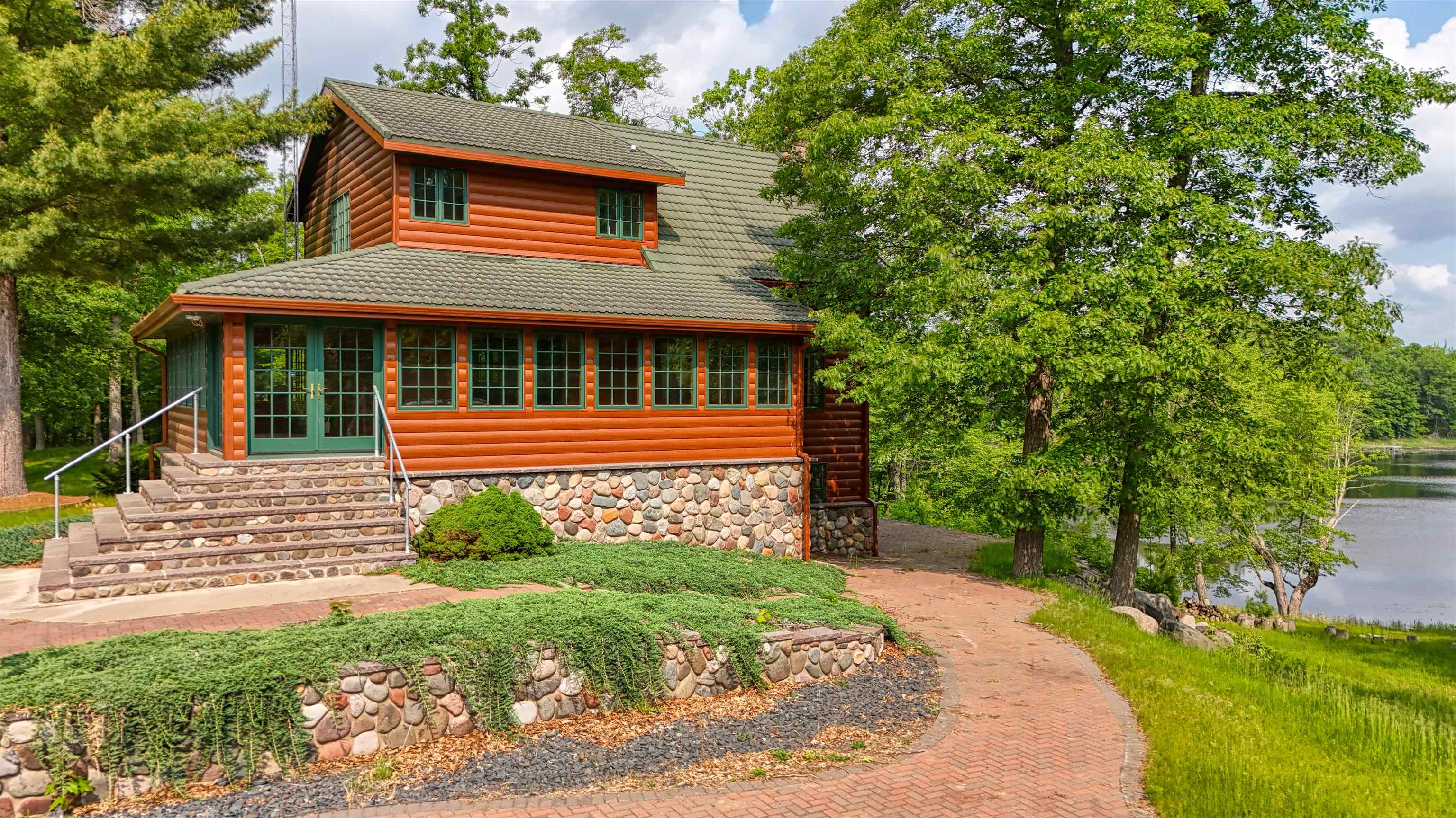1881 County Road A Spooner, WI 54801 - Photo 12 of 54 Log home with french doors, stone siding, and log veneer siding