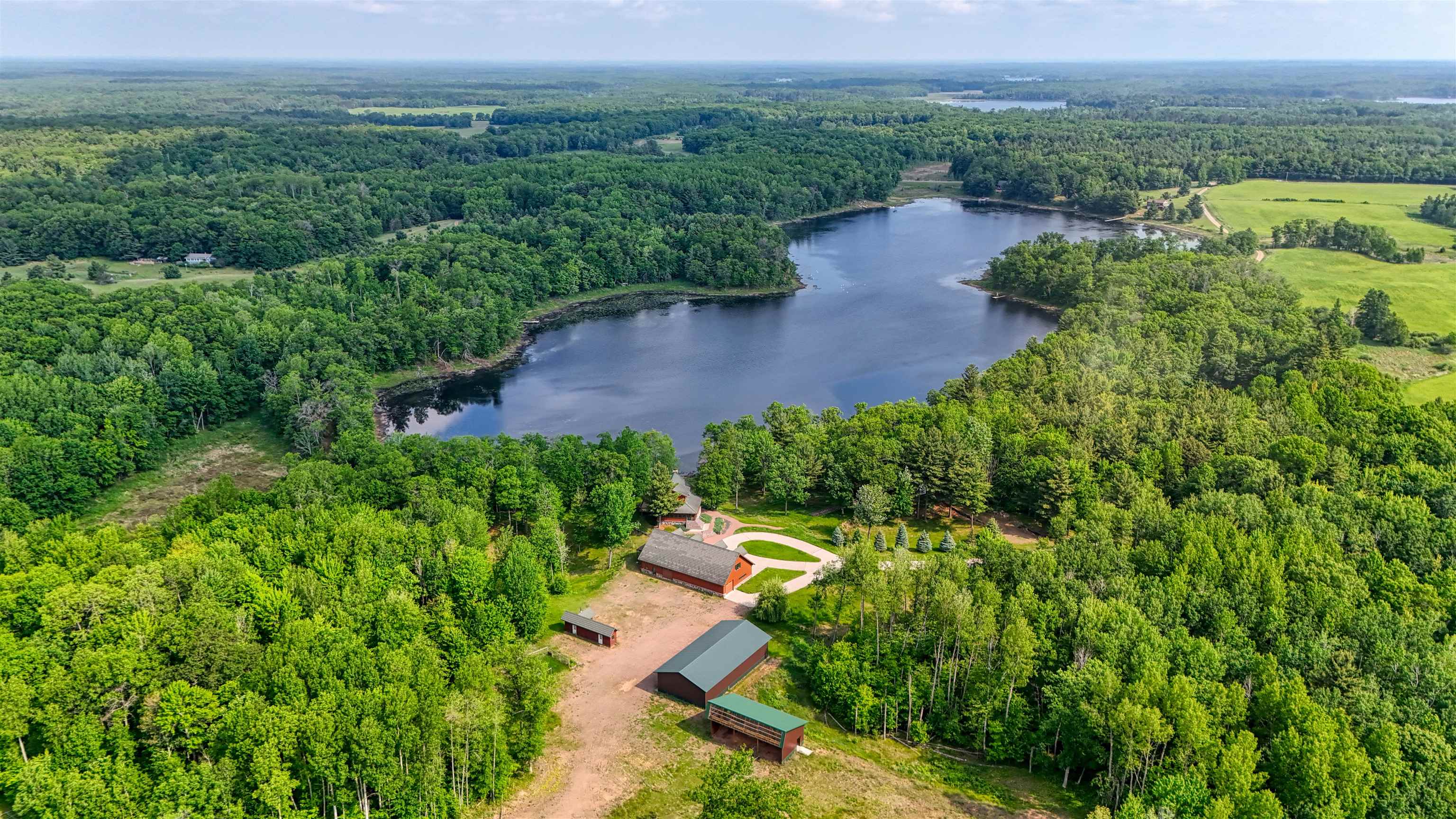 1881 County Road A Spooner, WI 54801 - Photo 2 of 54 Drone / aerial view of a forest and a large body of water