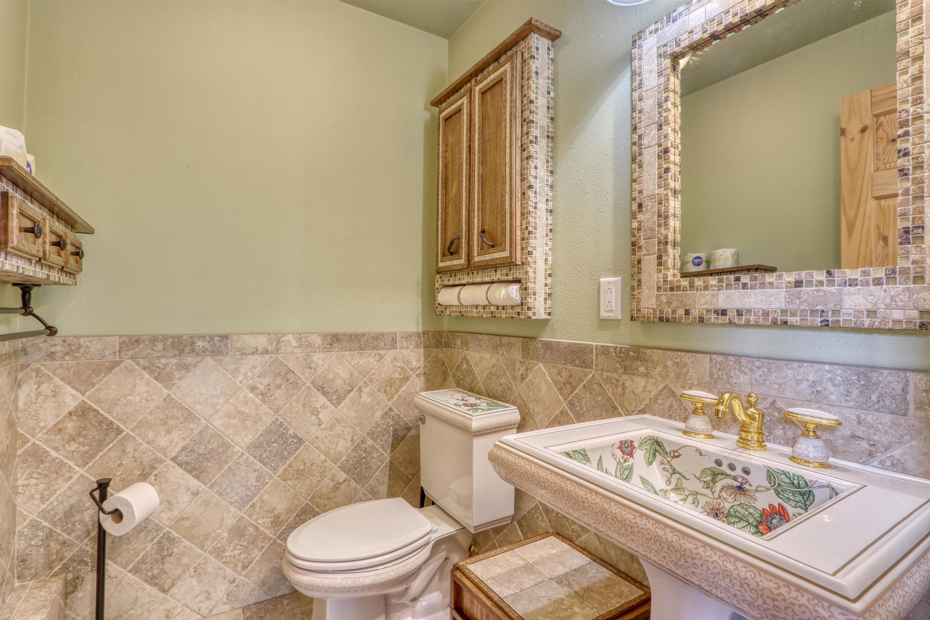 1881 County Road A Spooner, WI 54801 - Photo 31 of 54 Bathroom featuring toilet, a sink, and tile walls
