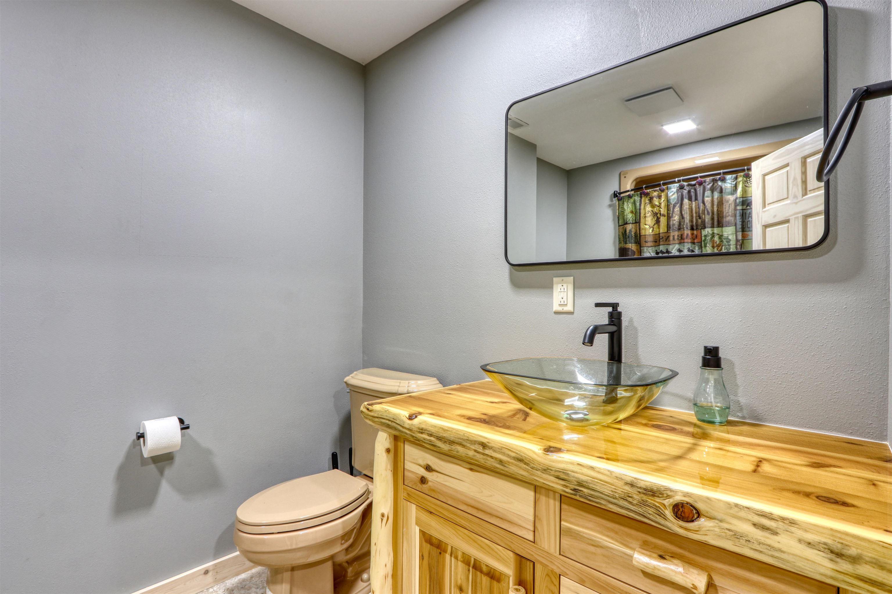 1881 County Road A Spooner, WI 54801 - Photo 43 of 54 Full bath featuring toilet, vanity, baseboards, and a shower with shower curtain