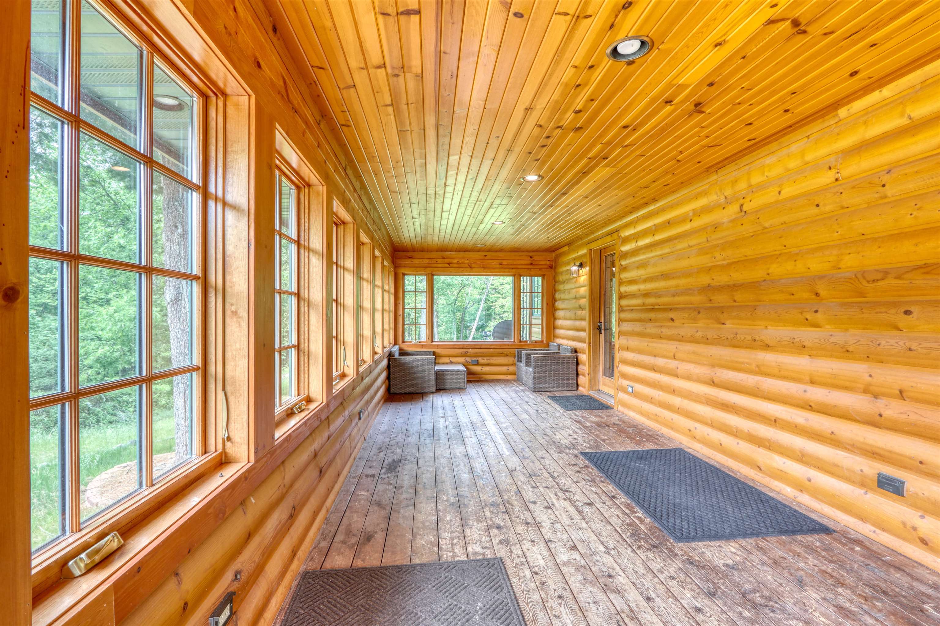 1881 County Road A Spooner, WI 54801 - Photo 45 of 54 Unfurnished sunroom featuring rustic walls, wood ceiling, hardwood / wood-style flooring, and recessed lighting
