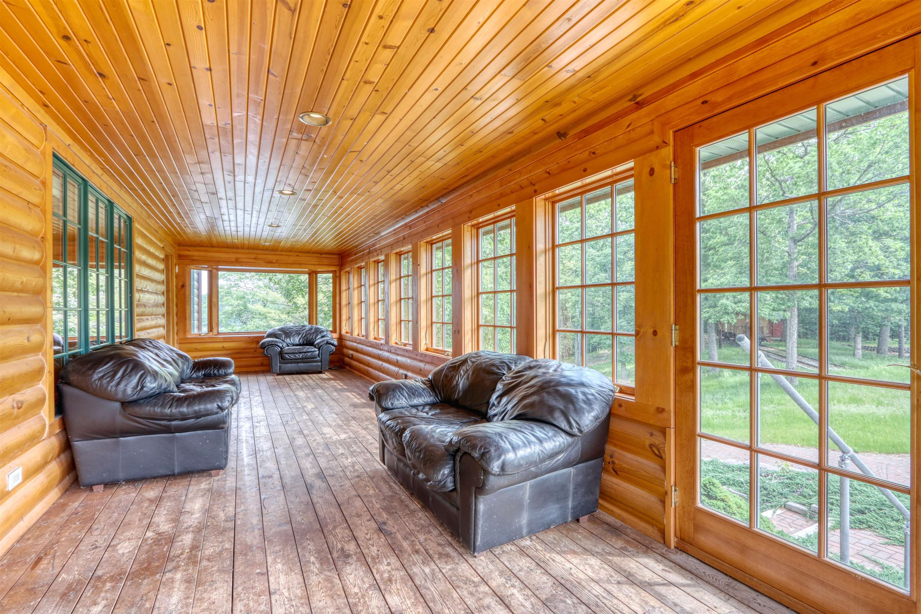 1881 County Road A Spooner, WI 54801 - Photo 46 of 54 Sunroom with rustic walls, french doors, wood-type flooring, and wood ceiling
