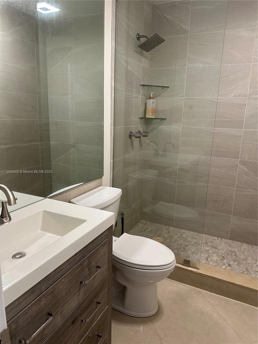 6600 Northeast 22nd Way, Unit 2304 Fort Lauderdale, FL 33308 - Photo 6 of 11 a bathroom with a sink a toilet and shower