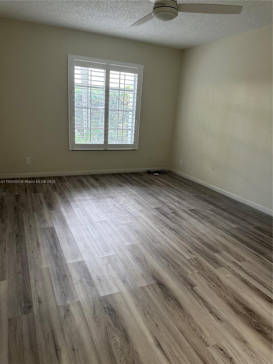 6600 Northeast 22nd Way, Unit 2304 Fort Lauderdale, FL 33308 - Photo 7 of 11 an empty room with wooden floor and windows
