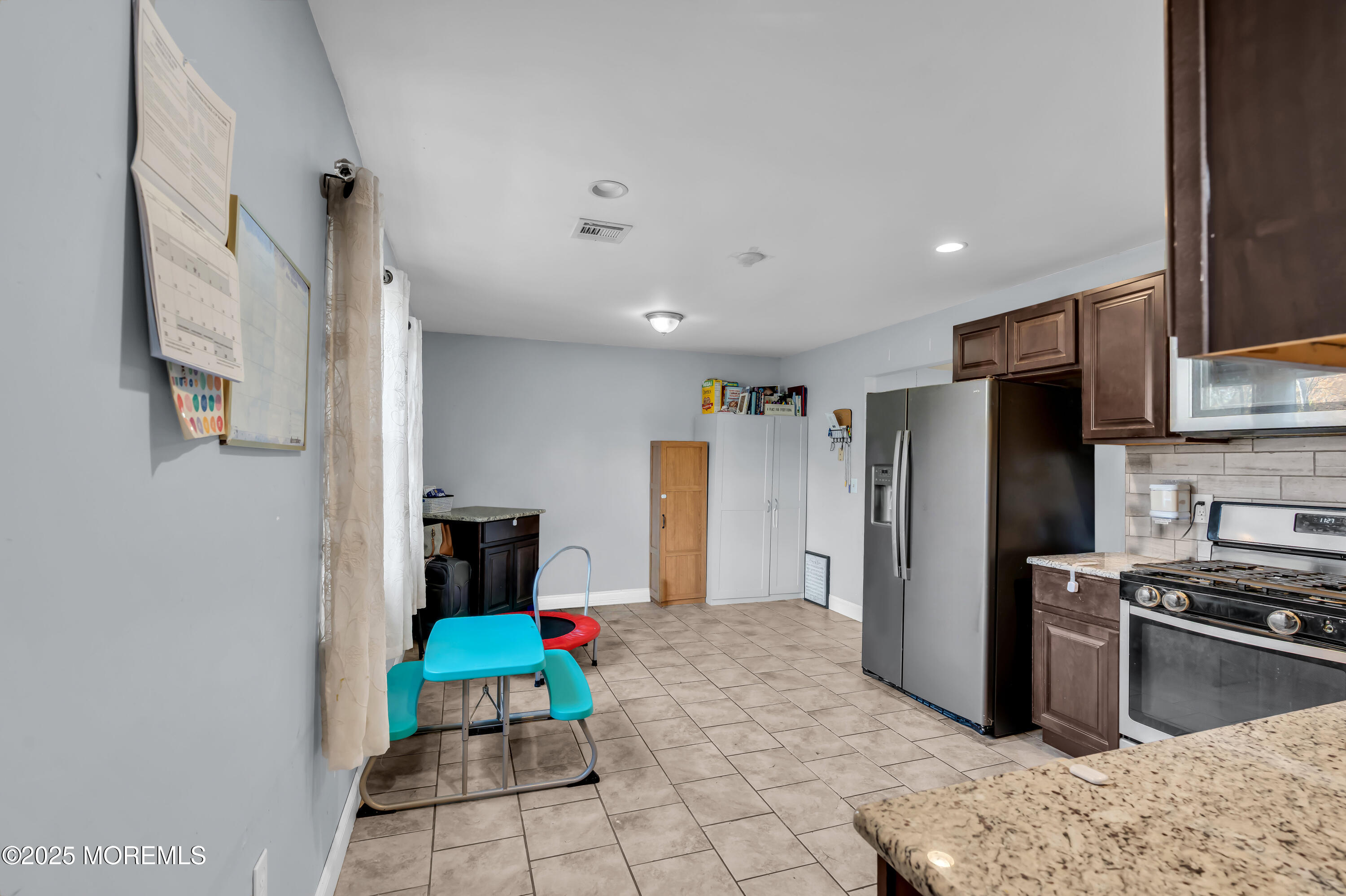 355 Western Boulevard Bayville, NJ 08721 - Photo 13 of 39 a kitchen with stainless steel appliances kitchen island granite countertop a refrigerator and a stove top oven