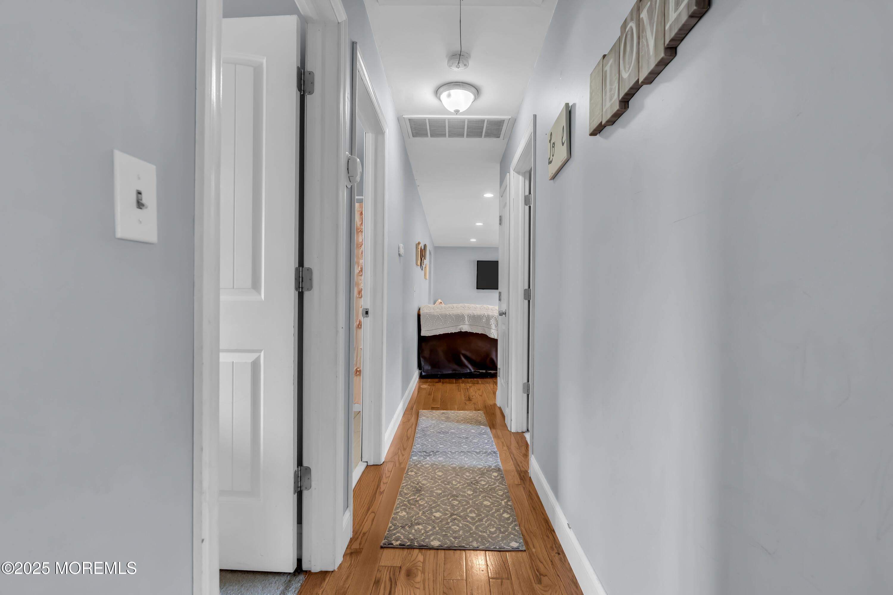 355 Western Boulevard Bayville, NJ 08721 - Photo 19 of 39 a view of a hallway with wooden floor and staircase