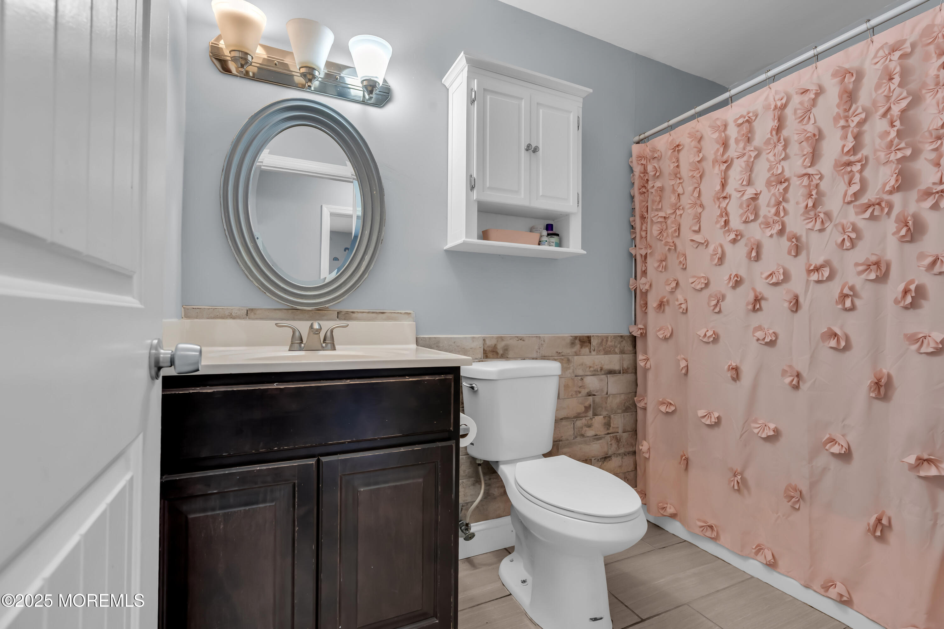 355 Western Boulevard Bayville, NJ 08721 - Photo 20 of 39 a bathroom with a sink a toilet and a mirror
