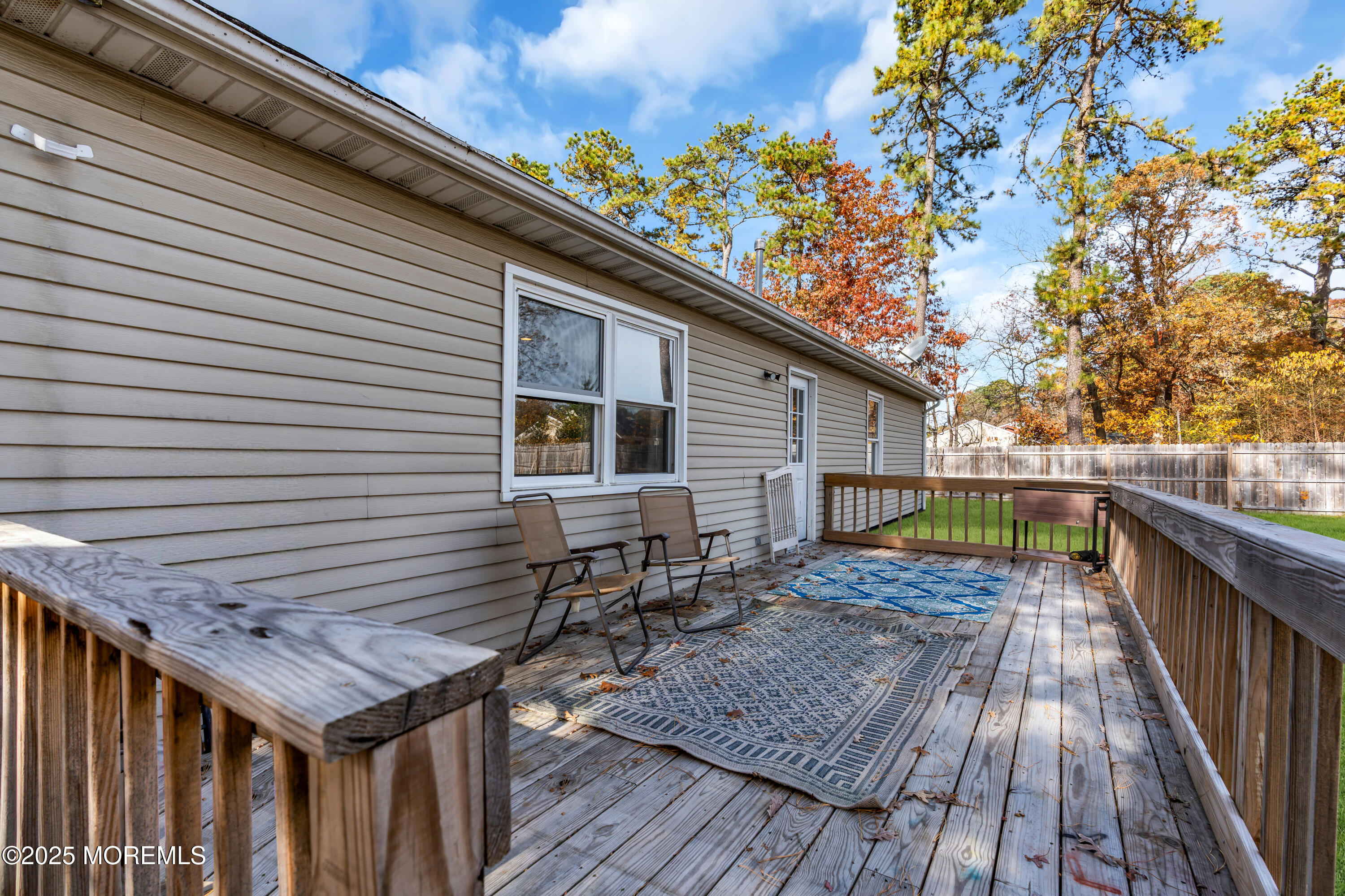 355 Western Boulevard Bayville, NJ 08721 - Photo 22 of 39 a balcony with wooden floor and fence